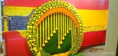 an elaborately decorated door with flowers and beads on the front is shown in yellow, red, and orange