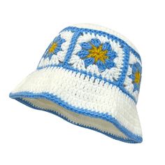 a white and blue crocheted hat with yellow flowers