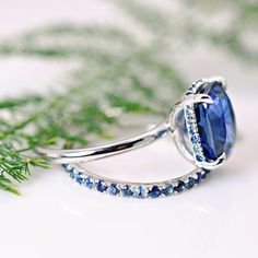 a ring with a blue stone surrounded by diamonds