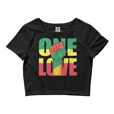 Introducing the One Love Rasta Crop Top - the perfect addition to your summer wardrobe! This stunning crop top is designed with a vibrant Rasta color scheme, featuring bold green, yellow, and red stripes that are sure to turn heads. Made from a soft and comfortable cotton blend, this crop top is perfect for keeping you cool and comfortable on those hot summer days. The relaxed fit and sleeveless design make it easy to wear and style, while the cropped length adds a trendy touch to any outfit. Th Fitted Green Crop Top With Graphic Print, Green Letter Print Crop Top, Fitted Green Cropped T-shirt For Summer, Trendy Green Crop Top For Streetwear, Green Letter Print Crop Top For Summer, Green Letter Print Crop Top For Streetwear, Green Short Sleeve Crop Top With Graphic Print, Green Graphic Print Short Sleeve Crop Top, Casual Green Crop Top With Graphic Print