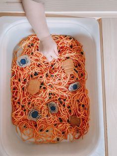 someone's hand on top of a fake spaghetti monster