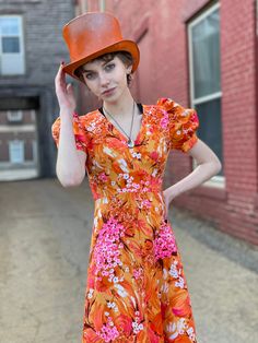 "Extreme Bight Mood Puff Sleeve 70s Hawaiian Print Orange and Pink Spring Maxi Dress. Here comes the sun. In excellent condition with no flaws of note. No tags. Feels synthetic. Back vinyl zip with hook and eye at neck. So beautiful Bust 31\" Waist 24\" Hip 36\" Length 49\" Please message me with questions before purchasing. All sales are final and ship fast from the Vermont shop. Find us on Instagram @anasclosetfullofcolor Thankyou! More vintage dresses here: https://www.etsy.com/shop/anastasia Vintage A-line Dress For Vacation, Vintage A-line Vacation Dresses, Vintage Tropical Print Dresses For Spring, Vintage Dresses With Tropical Print For Spring, Retro Orange Dress For Garden Party, Orange Retro Dress For Garden Party, Retro Fitted Vacation Dress, Vintage A-line Beach Dresses, Fitted Retro Vacation Dress