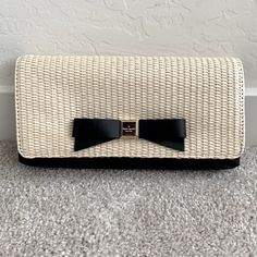 - Handheld Clutch In Natural Straw And Smooth Leather - Front Iconic Bow Detail Engraved With Kate Spade New York Signature - Fold Over Flap With Hidden Magnetic Closure - The Lined Interior Has A Flat Slip Pocket - Color: Black/Natural - Dimensions: 5''H X 9''W X 1''D Elegant Black Summer Clutch, Kate Spade Elegant Formal Clutch, Elegant Kate Spade Clutch For Formal Occasions, Formal Kate Spade Clutch, Elegant Formal Kate Spade Clutch, Chic Rectangular Kate Spade Clutch, Leather Satchel Handbags, Small Tote Bag, Kate Spade Wallet