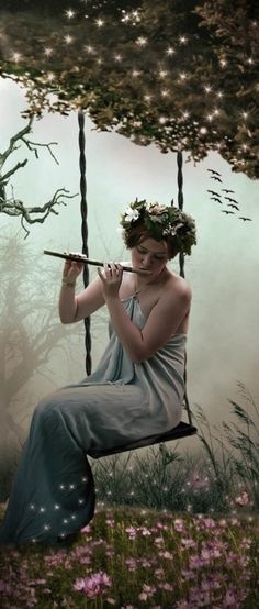 a woman sitting on a swing with flowers in her hair