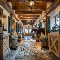 a horse is standing in the middle of a long hallway with barrels and plants on either side