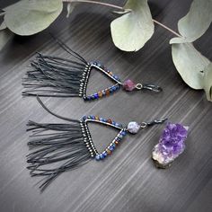 I was so inspired by the shapes and colors in the salt mountains in Iran. I decided to replicate them in a pair of triangle hoop earrings. To pull out some of the colors, I used 8mm starcut lightning agate, 3mm faceted sapphires, and 3mm hessonite garnet. The fringe on the bottom is black nylon-coated steel beading wire. It is stiff, yet not scratchy so it will hold the fun flare but not scratch you.Each earring is about 3.75” long and weighs 3.85g. The earrings are constructed from sterling sil Bohemian Adjustable Triangle Earrings, Bohemian Triangle Adjustable Earrings, Adjustable Bohemian Triangle Earrings, Handmade Triangle Bohemian Jewelry, Handmade Bohemian Triangle Jewelry, Bohemian Triangle Nickel-free Earrings, Bohemian Triangle Earrings With Ear Wire, Nickel-free Triangle Bohemian Jewelry, Nickel-free Bohemian Triangle Jewelry