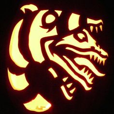 a carved pumpkin with an image of a dragon on it's face and the word,