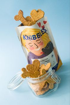 a bag of knubbles next to a jar of dog treats on a blue background