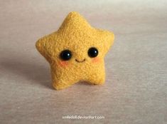 a small yellow felt star with black eyes