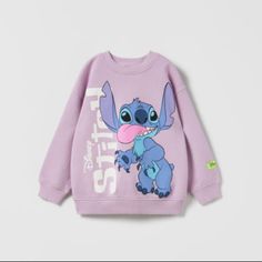 Round Neck Sweatshirt With Long Sleeves. Rib Trim. Stitch Disney Print. Casual Purple Sweatshirt With Cartoon Print, Disney Long Sleeve Top With Cartoon Print, Purple Long Sleeve Cartoon Print Sweatshirt, Purple Long Sleeve Sweatshirt With Cartoon Print, Purple Crew Neck Top With Cartoon Print, Cute Purple Tops With Character Print, Playful Purple Tops With Cartoon Print, Cute Long Sleeve Purple T-shirt, Cute Zara Long Sleeve Sweatshirt