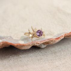 At the heart of this enchanting ring lies a captivating amethyst gemstone, with a radiant purple hue. Known for its soothing and spiritual properties, amethyst embodies grace and serenity. Delicate coral details surround the stone with little diamond accents, reminiscent of the marine life that thrives beneath the waves. The intricate coral design brings the wonders of the sea to your fingertips. 6 1mm diamonds .4ct Amethyst Currently a size 6 This ring can be sized up or down 2 sizes One of a k Fine Jewelry Lavender Amethyst Birthstone Ring, Lavender Amethyst Birthstone Ring, Purple Amethyst Ring With Tanzanite Accent Stones, 14k Gold Amethyst Ring With Lavender Gemstone, Purple Amethyst Birthstone Ring With Gemstone Accents, Lavender Amethyst Birthstone Ring With Prong Setting, Purple Amethyst Birthstone Ring In 14k Gold, 14k Gold Amethyst Ring For Birthstone, Lavender Amethyst Ring With Center Stone