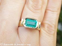 Superb handmade ring, it's crafted in solid 14K yellow gold and features a gorgeous rectangular emerald-cut Colombian emerald set in a full bezel setting that raises 5.0 from the finger, the descending shoulders have 4.5 mm width, it has round edges and high polished finish, this statement ring is suitable as Anniversary ring or Mother's Day present ITEM DETAILS: Main stone: Genuine or natural Colombian emerald Carat weight: 1.85 ct (8.55 x 5.70 mm) Shape or cut: Emerald cut Color: Medium to dee Emerald Solitaire Ring, Emerald Set, Solitaire Setting, Colombian Emeralds, Mothers Day Presents, East West, Anniversary Ring, Emerald Ring, Deep Green