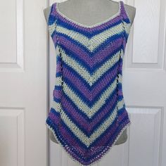 "Soft cotton yarn makes up this delightful and playful striped summer tank top.  Perfect weight for the season with a flattering diagonal stripe pattern on both front and back. The color and pattern is royal blue,light blue and purple striping which follows the dictate of the colors in the yarn.  It will fit a woman's size  medium.  Top can be worn over a bathing suit, camisole or halter top layered. or by itself.   Measurements: ( taken lying flat)                               Bust, 36\"- 38\"                               Hip Area  36\"-40\"                               Under Arm Side  12 1/2\", over all length from shoulder to peak on hem is 28\". There is comfortable stretch in excess of those measurements giving the top a wonderful drape. All of my tank tops and camisoles are hand k Sleeveless Crochet Knit Top For Beach, Bohemian Striped Tops For Vacation, Casual Tank Sweater Vest For Vacation, Beach Tank Knit Top, Beach Tank Vest Knit Top, Beach Tank Knit Vest Top, Striped Crochet Top For Summer, Multicolor Sleeveless Knit Top For Summer, Multicolor Knit Top For Summer