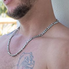 The Bellamy Stainless Steel Figaro Chain Necklace is a nod to timeless style and quiet strength. This silver-tone chain boasts a simple yet unique pattern that sets it apart. As you fasten it, the smooth texture against your skin creates a sense of understated luxury. Consider this necklace a potential staple piece in every modern man's collection – versatile, dependable, and undeniably stylish. When it comes to men’s necklaces, stainless steel brings strength, shine, and street cred to the tabl Stainless Steel Figaro Chain Necklace, Diamante Bracelet, Motif Simple, Leather Choker Necklace, Figaro Chain Necklace, Chain For Men, Eyebrow Piercing, Understated Luxury, Pearl Choker Necklace