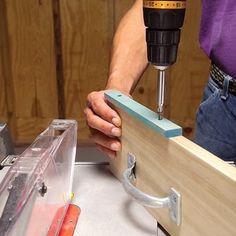 a person is using a driller to cut wood with a viset and other tools