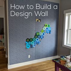 a room with a wall that has flowers on it and the words how to build a design wall