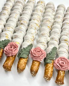 four different types of pastries with flowers on them are lined up in a row