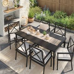 an outdoor table and chairs set up on a patio