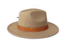 The Rito Hat from the Oaxaca Collection Type: Center Dent Wide Brim FedoraSpecifications: Adjustable Size- With a tie of a knot, adjust the fit of your hat to the ideal size from 21 ¼ to 23 ¼ inches.Dimensions: Wired Brim: 2 7/8", Crown: 4"Color: CamelMaterials: 65% Cotton , 35% Polyester Vegan leather hat bandTurkey featherOrigin: All of our hats begin in Ecuador as the body is molded, then completed in Tucson, AZ where they are shaped, trimmed and designed with artisanal hatbands, leather good Winter Adjustable Fedora Panama Hat, Adjustable Brown Fedora With Flat Bill, Adjustable Beige Fedora Felt Hat, Adjustable Brown Hat Bands With Flat Bill, Adjustable Brown Felt Hat With Flat Bill, Adjustable Panama Hat For Beach In Fall, Adjustable Beige Wide Brim Felt Hat, Adjustable Flat Bill Hat Bands For Fall, Casual Adjustable Beige Felt Hat