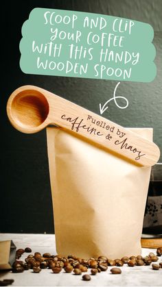 image of a wooden coffee spoon clipped to the coffee bag to keep it fresh. It is engraved with the words fuelled by caffeine and chaos Caffeine And Chaos, Coffee Ritual, Coffee Scoop, Wooden Spoon, Wooden Spoons