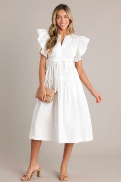 Impress in this charming Pure Enchantment 100% Cotton Midi Dress in White! Soft and breathable, this dress is perfect for both casual and formal occasions. With its flattering midi length, you'll radiate joy and confidence wherever you go. Go ahead, let the enchantment begin! This white midi dress features a v-neckline, subtle chest pleats, a discrete side zipper, a thick waistband with a self-tie belt, a smocked waist insert, functional hip pockets, a single tier, and ruffled short sleeves.   100% Cotton  Unlined  Manufactured in China  Designed in the USA  Model is wearing a size small Sorority Rush Dresses, Halter Bridesmaid Dress, Rush Dresses, Summer Escape, White Midi, Dress Bra, Cotton Midi Dress, Black Dresses Casual, Little White Dresses