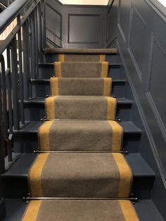 a set of stairs with yellow and gray carpet