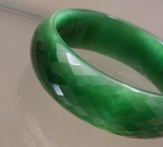 Genuine Natural Green Cat Eye Faceted Glass Bangle Crystal Crystal Emerald green Cat Eye Bangle Lovely like new Emerald Green Glass Bangle.. comes in its own gift box.. would make a nice gift. It is .75 inches wide and 2.40 inches in diameter so a little smaller than common size bangles.. Has some weight to it Green Handmade Bracelets For Formal Events, Green Handmade Bracelets For Formal Occasions, Green Cat Eye, Green Cat, Glass Bangles, Faceted Glass, Green Glass, Crystal Glass, Emerald Green