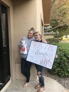 two women holding up a sign that says boss art