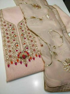 Item Overview ATHARVA Hand Embroidered Salwar Kameez w/Embroidery Neck Peach/Chiffon Gota Work Dupatta/Custom Stitch/Tunic/Pants/Patiala Salwar/ Dno. CH1548 Fabric: * Shirt Chanderi Silk - Embroidered Neck- Peach - 2.5 Mts Beautiful Hand Embroidere Neck. * Dupatta: Chiffon Chinnon Dupatta- 2.5 Mts- Beautiful Gota Patti work- Peach * Bottom Santoon Silk 2.5 Mts. Excusive Hand Embroidered Party Wear Punjabi Suit. Customization: * Fabrics Customization: Designs Can be made in different Fabrics. *Co Semi-stitched Pink Lawn Suit With Dabka Work, Pink Embroidered Lawn Suit, Pink Georgette Lawn Suit With Chikankari Embroidery, Peach Georgette Sets With Zari Work, Elegant Pink Lawn Suit For Navratri, Unstitched Peach Sets With Zari Work, Pink Unstitched Resham Embroidered Suit For Navratri, Pink Organza Salwar Kameez With Zari Work, Pink Embroidered Georgette Lawn Suit