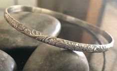 This listing is for one Sterling Silver Stacking Hawaiian Style Bangle Bracelet. This beautiful pattern bangle is 4.14mm wide and 1.37mm thick and is sure to be a unique addition to your favorite stacking bangle bracelets! This beautiful bangle is lovely and super strong. All bangles are soldered, hammered, tumbled for hours and hand-polished just for you! My bangle sizes are available in the following sizes: X-Small - 2 inch diameter - child - 6.25 inch circumference Small - 2 1/4 inch diameter Bohemian Adjustable Engraved Bangle, Adjustable Etched Round Bangle, Adjustable Etched Bangle, Bohemian Stamped Bracelets For Wedding, Bohemian Stamped Bracelet For Wedding, Adjustable Carved Cuff Bangle Bracelet, Unique Adjustable Engraved Bangle, Adjustable Carved Cuff Bangle, Bohemian Etched Bangle Bracelet