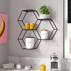 a kitchen counter with cups and mugs on it