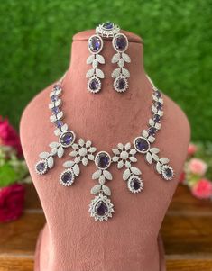 Gorgeous fine quality lavender purple CZ lab diamonds studded necklace set in White gold plating and matching Earrings, maangtika *Comes with Statement matching earrings and maangtika  *AAA quality cubic zirconia used. *Highest quality and craftsmanship Necklace Fitting is adjustable with an adjustable metal chain  Necklace length 15 inches (adjustable length) Each earring weighs 15 gms Earrings length 2.4 inches  Earrings Closure: Pushback Item is ready to be shipped from New Delhi, India  IMPO Purple Diamond Necklaces For Wedding, Purple Diamond Necklace For Wedding, Lavender Jewelry With Diamond Accents For Wedding, Purple Diamond Wedding Necklace, Lavender Wedding Jewelry With Diamond Accents, Dazzling Purple Wedding Jewelry, Dazzling Purple Jewelry With Diamond Accents, Purple Cubic Zirconia Necklaces For Party, Purple Cubic Zirconia Jewelry With Sparkling Stones