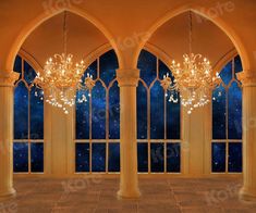 an empty room with large windows and chandeliers