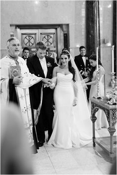 a bride and groom walking down the aisle at their wedding ceremony in black and white