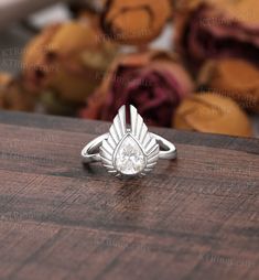 a diamond ring sitting on top of a wooden table