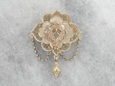 Dating to the height of the Victorian Era, this vintage brooch features all the small details that the era is known for. Delicate engraving over warm yellow gold crowns the top, giving the traditional gold a soft texture. Particularly nice is the echo of the ivy motif on the scalloped frame. Love this piece but want to make it more versatile, we here at Market Square Jewelers along with our master metalsmiths can convert this fantastic brooch into a necklace or pendant for an additional fee, ple Traditional Yellow Gold Collectible Brooch, Antique Wedding Brooch With Intricate Design, Antique Baroque Brooches For Wedding, Yellow Gold Filigree Brooches For Wedding, Ornate Yellow Gold Wedding Brooch, Wedding Yellow Gold Filigree Brooches, Victorian Wedding Brooches With Intricate Design, Heirloom Wedding Brooches With Intricate Design, Traditional Yellow Gold Brooches For Formal Occasions