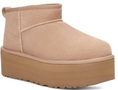 A modern interpretation of UGG's icon, the Ultra Mini reaches new heights with a leg-lengthening 2" platform. Offering a bolder look than ever, it's made with the same rich suede as the original, plus UGG's UGGplush™ wool blend for signature softness. The outsole of this product is either a SugarSole™ outsole, which is a responsible compound using sugarcane foam that allows UGG to reduce dependency on fossil fuels by replacing petroleum-based ethylene, or a Treadlite by UGG™ outsole. DETAILS: Suede upper Overlock stitch detailing on seams, Rear pull tab, Asymmetrical topline 17mm UGGplush™ 80% upcycled wool, 20% TENCEL™ Lyocell lining or 17mm UGGplush™ 60% upcycled wool, 40% TENCEL™ Lyocell lining 17mm UGGplush™ 80% upcycled wool, 20% TENCEL™ Lyocell insole or 17mm UGGplush™ 60% upcycled w Ugg Platform Boots Outfit, Ugg Platform Boots, Platform Boots Outfit, Ugg Platform, Short Ugg, Ugg Ultra Mini, Platform Boots Women, Ugg Classic Ultra Mini, Jerome Dreyfuss