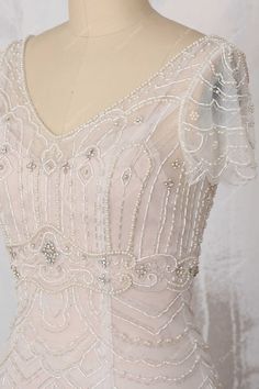 the back of a dress with beading on it