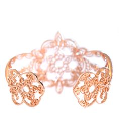 Like a starbust shining brightly, our Star cuff bracelet radiates style through a blend of floral motifs, and scrolling henna-inspired filigree. Its scalloped edges are highlighted by beads of granulation: a traditional craft technique often associated with jewelry of ancient cultures. You'll also discover subtle odes to the Filienna brand with flourished "f" motifs subtly nestled into the Star Cuff's design. Filienna jewelry is made from our proprietary Filienna blush silver alloy – a blend of Ornate Rose Gold Jewelry With Intricate Design, Elegant Rose Gold Bracelets For Festive Occasions, Elegant Festive Rose Gold Bracelets, Elegant Adjustable Filigree Cuff Bracelet, Adjustable Luxury Bracelets With Intricate Design, Luxury Adjustable Bracelets With Intricate Design, Traditional Rose Gold Filigree Jewelry, Adjustable Ornate Cuff Bracelet With Intricate Design, Ornate Adjustable Cuff Bracelet With Intricate Design