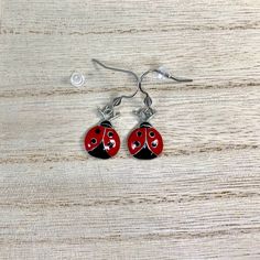 Red and Black Ladybug Charms on Surgical Stainless Steel ear wires All hook style earrings come with Silicone stoppers Measures:  just over 1/2 inch long and just under 1/2 inch wide  Enamel Zinc Alloy Charms are lead, cadmium and nickel free! Comes in small gift box Ships in 1 to 3 days, Orders over $35 ship free within the USA! To see what else I offer: https://www.etsy.com/shop/treasures2cherish Red Pierced Enamel Earrings, Red Enamel Pierced Earrings, Red Hypoallergenic Metal Jewelry, Hypoallergenic Red Metal Jewelry, Red Enamel Earrings, Adjustable Enamel Earrings With Ear Wire, Red Metal Earrings, Hypoallergenic Red Metal Earrings, Red Enamel Dangle Earrings