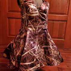 a mannequin wearing a camo dress in front of a wooden door with wood flooring