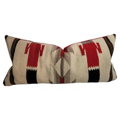 a decorative pillow that has been made with red, black and white colors