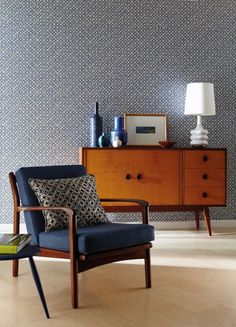 a living room scene with focus on the arm chair and side table in the foreground