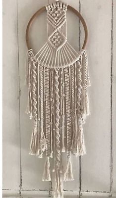 a white macrame hanging on a wall