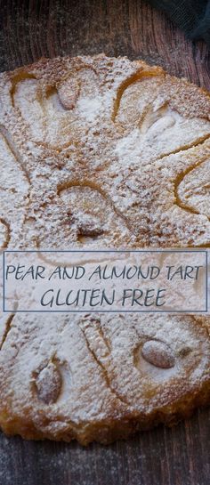 a close up of a cake on a table with a sign that says pear and almond tart gluten free