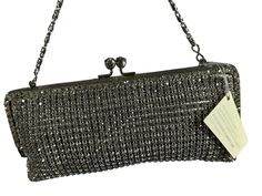 Lovely purse encrusted with hundreds of sparkling clear Swarovski crystals with great craftsmanship and there are no missing crystals.  Measurements are 7"8  wide, 3"3 high, 1/2 deep with a 44"5 shoulder strap with a 21" drop. On the interior there is one main compartment lined in fabric with a small back pocket, top kiss lock closure and the shoulder strap can be tucked inside and used as a clutch. I don't know if purse is new, but it looks in excellent condition and comes with original tags.  If you need additional pictures please let me know.  Contact If you have zero, excessive or hidden feedback please email me. Items are sold as is and if you have an questions please let me know before you purchase item.  Shipping Shipping is done with USPS priority mail within the U.S. and shipping Designer Rhinestone Evening Bag For Formal Occasions, Designer Evening Bag With Rhinestones For Formal Occasions, Silver Evening Bag With Rhinestones For Cocktail, Silver Rhinestone Evening Bag For Cocktail, Sparkling Clutch Evening Bag For Formal Occasions, Luxury Silver Bags For Cocktail, Rectangular Sparkling Evening Clutch, Cocktail Clutch Bag With Rhinestones, Cocktail Clutch With Rhinestones