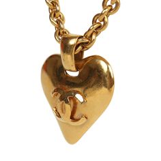 This Chanel Vintage Gold CC heart necklace features a statement heart interlocking CC logo pendant, a thick rolo chain, and a spring ring closure and 24K gold plated hardware. Origin: FranceCondition: Vintage; Excellent - This necklace shows signs of wear on metal including, scratching on pendant and chain and some minor discoloration.Accompanied by: BoxMeasurements: 12.5" chain, 2" x 1.7" pendant Gold Heart-shaped Jewelry With Logo Charm, Gold Heart Jewelry With Logo Charm, Heart Pendant Necklace Gold, Gold Ounce, Chanel Vintage, Rolo Chain, Cc Logo, Vintage Chanel, Heart Pendant Necklace