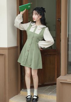 Faux two-piece pinafore blouse dress with a scallop collar, button front and mini twirl skirt. Concealed back zipper with waist ties. S: 14" across shoulders, 35" chest, 28" waist, 32" lengthM: 14.5" across shoulders, 36.5" chest, 29.5" waist, 32" lengthL: 15" across shoulders, 38" chest, 31" waist, 32" length Casual Mini Length Fake Two-piece Dress, Casual Mini Dress With Fake Two-piece Detail, Spring Mini-length Fake Two-piece Dress, Spring Mini Length Dress With Fake Two-piece Design, Spring Mini Length Fake Two-piece Dress, Long Sleeve Suspender Dress For Spring, Vintage Doll Collar Mini Dress For Spring, Spring Vintage Mini Dress With Doll Collar, Vintage Mini Dress With Doll Collar For Spring