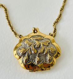 Absolutely lovely 1928 brand long necklace with openable large locket shaped like a change purse. Lovely acorn pattern on both sides of pouch charm.  Lovely! Vintage Medallion Locket Necklace With Charm, Vintage Hallmarked Locket Necklace For Keepsake, Golden Locket, Acorn Pattern, Large Locket, Claw Necklace, Change Purse, Long Chain, Long Necklace