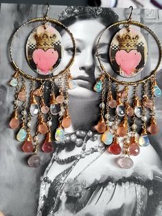 These chandelier earrings are made with the most gorgeous large Welo opal teardrops with green fire, Pink Strawberry Quartz, Lepidocrocite Quartz, glowing Himalayan Ice Quartz drops, sparkly Natural Zircon and exquisite pink Czech glass briolettes. They dangle from a gold filled circle frame looking like marble with striations of colour throughout but with that magnificent brilliance and flash.  The focal enamel pieces, created by the French artist Valerie from PoppyBis, feature gorgeous Claddag Bohemian Heart-shaped Earrings With Dangling Beads, Bohemian Teardrop Jewelry With Dangling Charms, Bohemian Heart Earrings For Wedding, Bohemian Heart-shaped Wedding Earrings, Heart Crown, Green Fire, Circle Frame, Ethiopian Opal Ring, Circle Frames